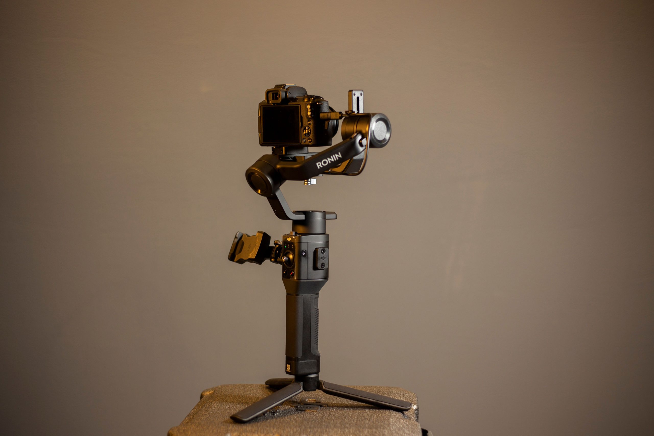 pexels photo 10300318 10300318 Studio shot of a DJI Ronin stabilizer holding a camera on a tripod. Perfect for videography needs.