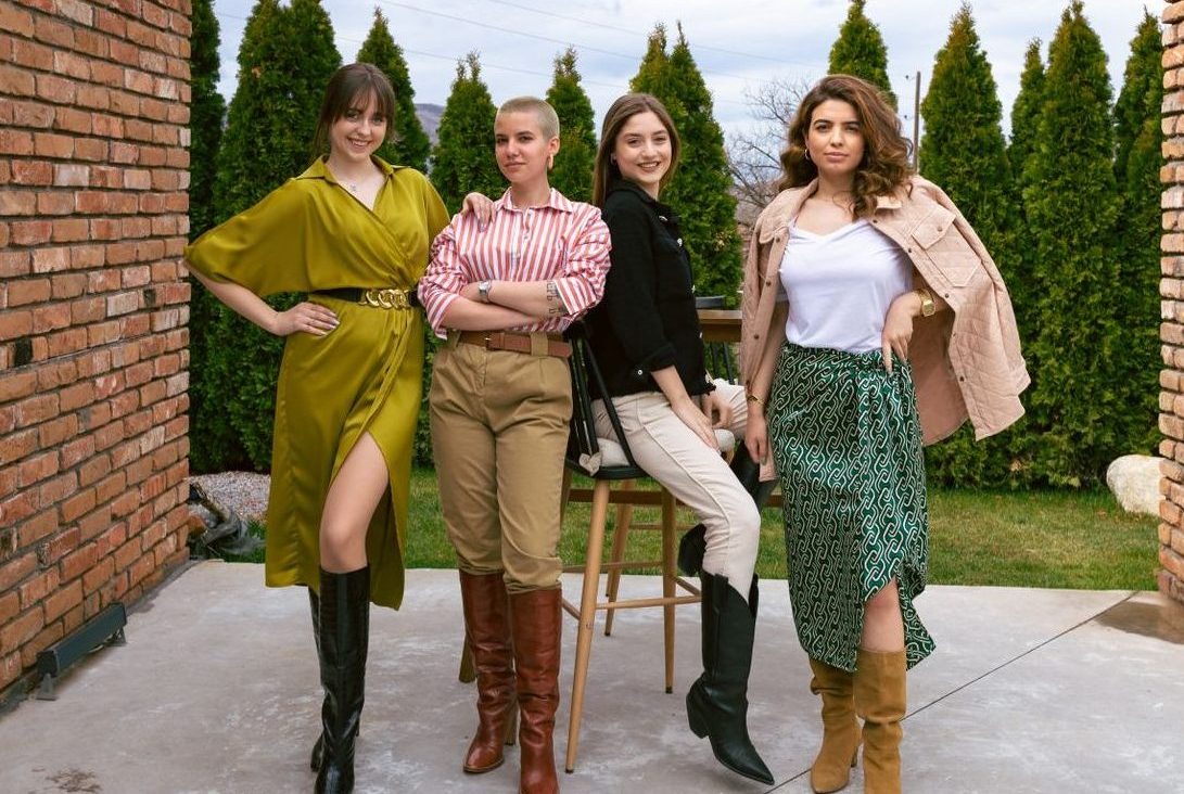 📸 Fashion & Editorial: Selling a Lifestyle, Not Just Garments Four women showcasing unique outfits and boots, posing confidently outdoors.