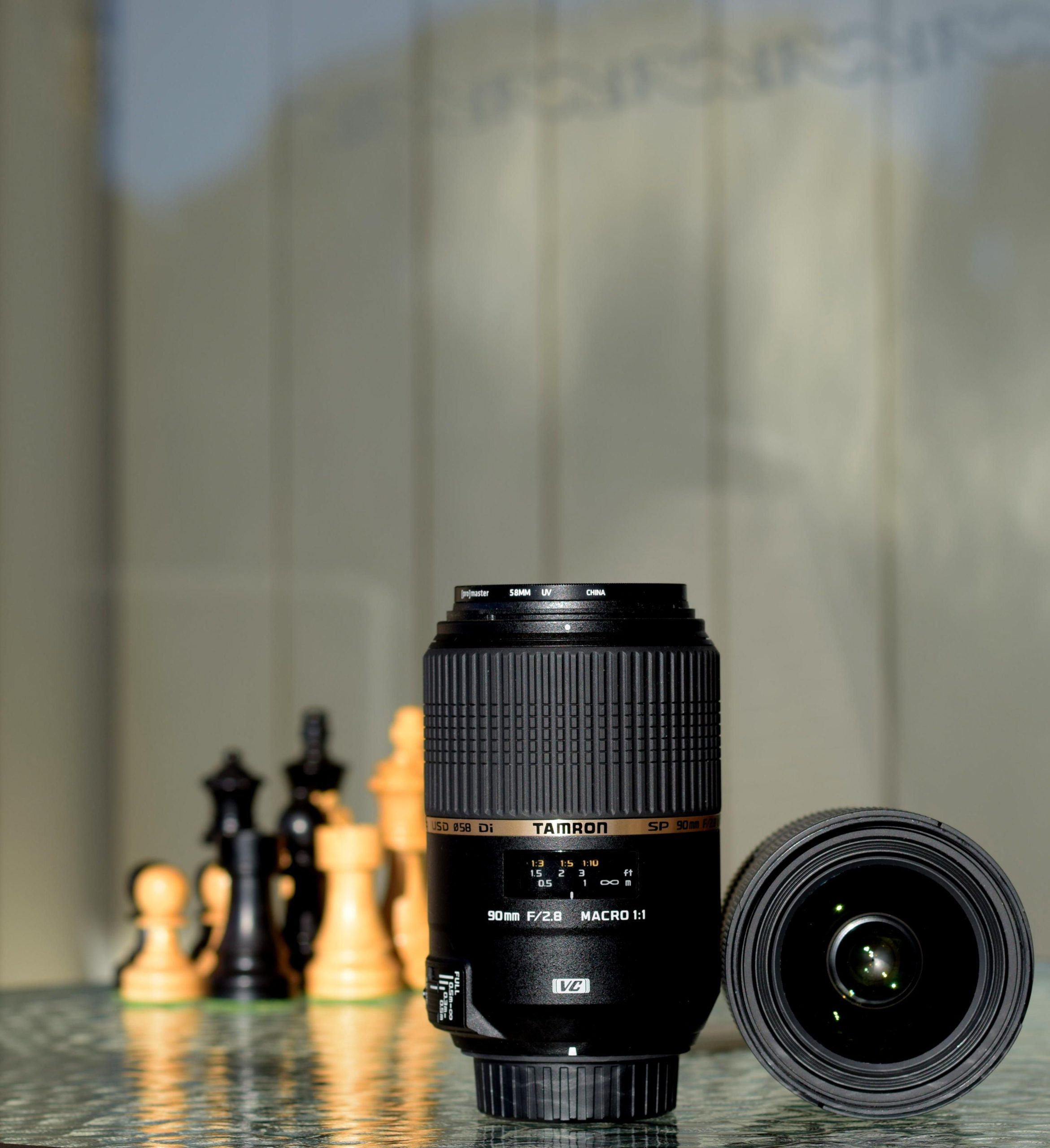 pexels photo 1602729 1602729 Photography lens and chess pieces placed on a reflective surface illustrating focus and strategy.
