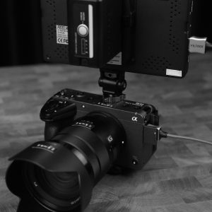 Professional camera rig featuring a lens and external monitor in a sophisticated setup.