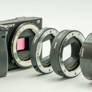 Close-up view of a vintage camera with lens and photography accessories. Ideal for photography enthusiasts.