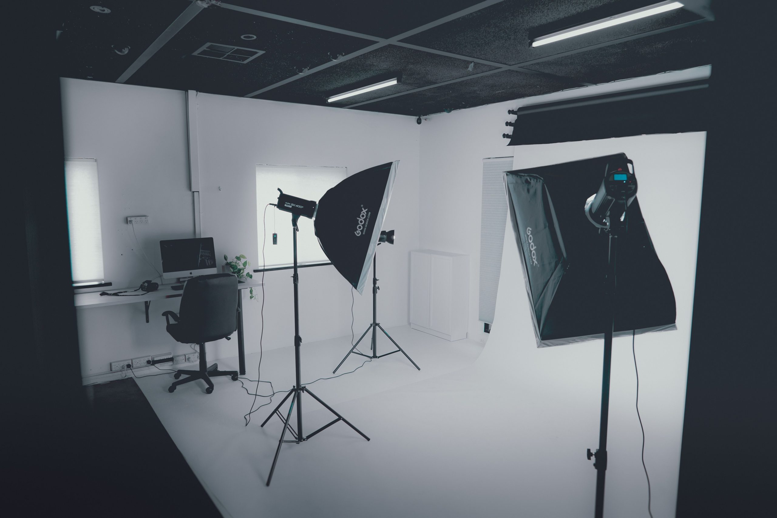 pexels photo 7383647 7383647 A modern photography studio with professional lighting equipment and a computer workstation.